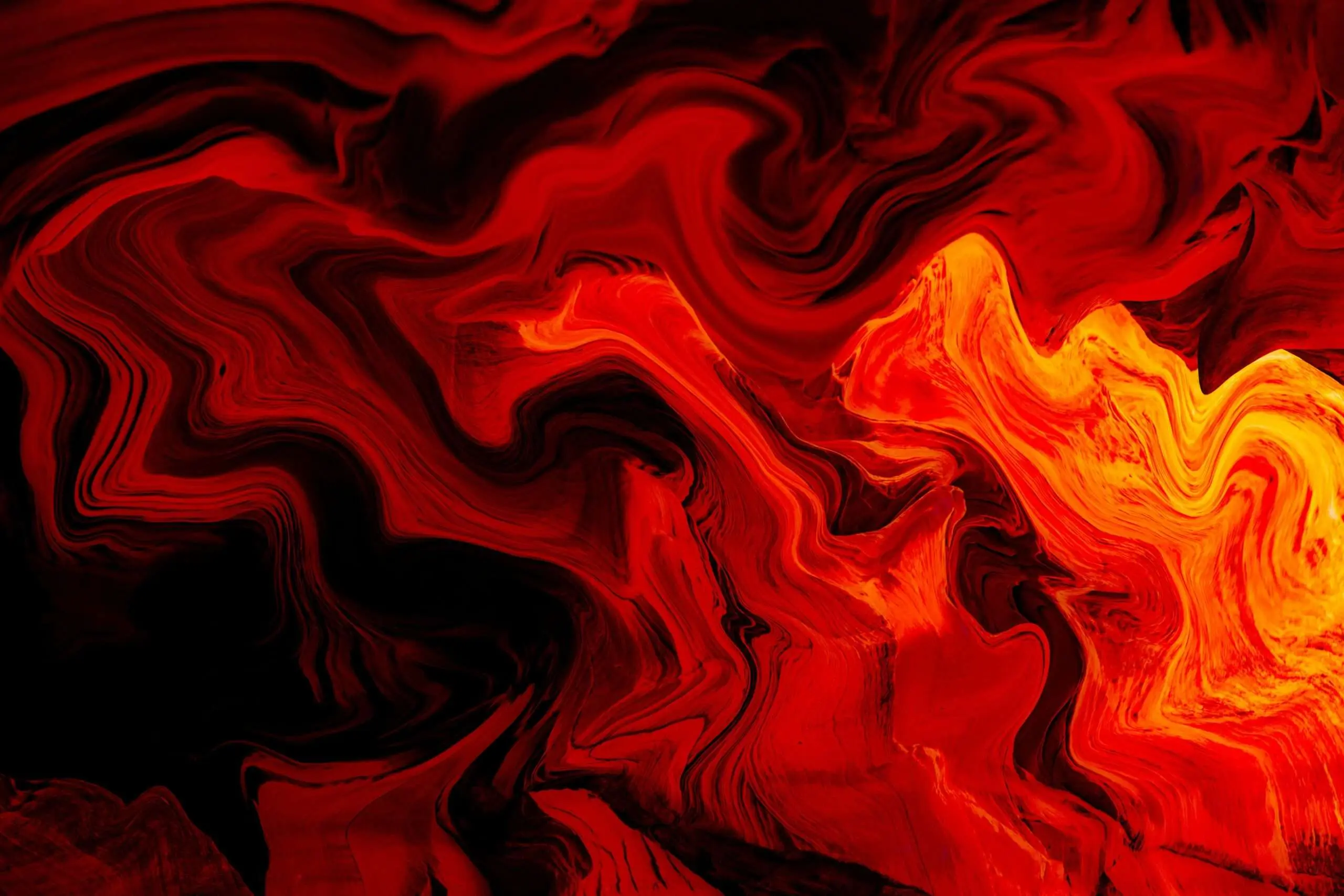 A dynamic abstract painting with swirling red, black, and yellow patterns resembling flames.