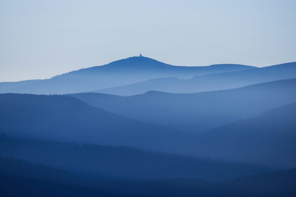 Unique Lending Solutions a blue mountains with a tower on top